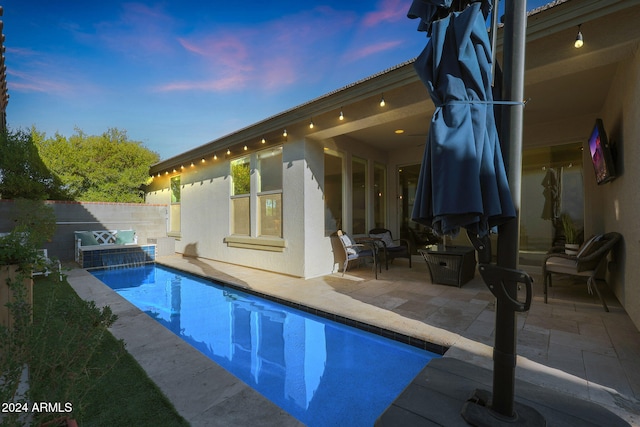 exterior space with a patio and a pool with hot tub