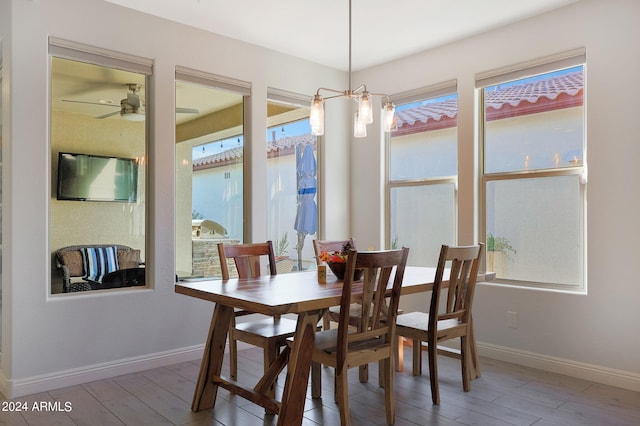 dining space with hardwood / wood-style floors and ceiling fan