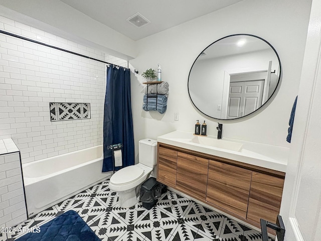 full bathroom with tile patterned floors, vanity, toilet, and shower / bath combo with shower curtain