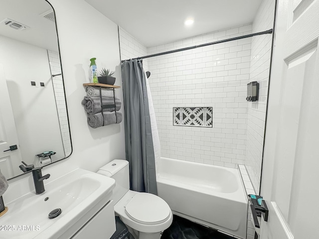 full bathroom with shower / tub combo with curtain, vanity, and toilet