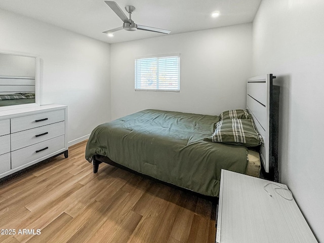 bedroom with ceiling fan and light hardwood / wood-style flooring