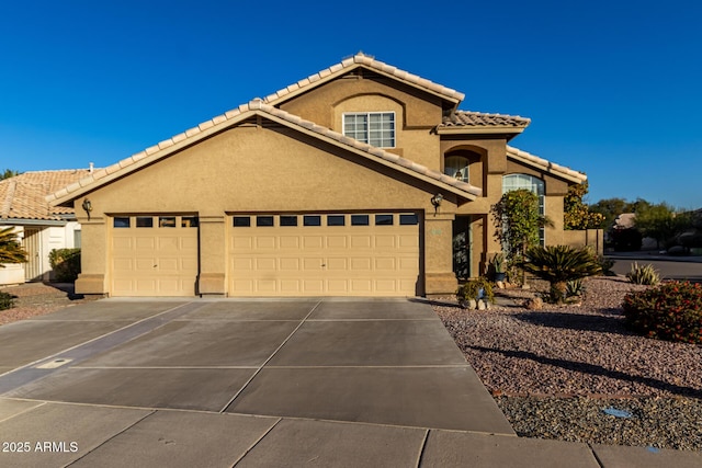 mediterranean / spanish-style home with a garage