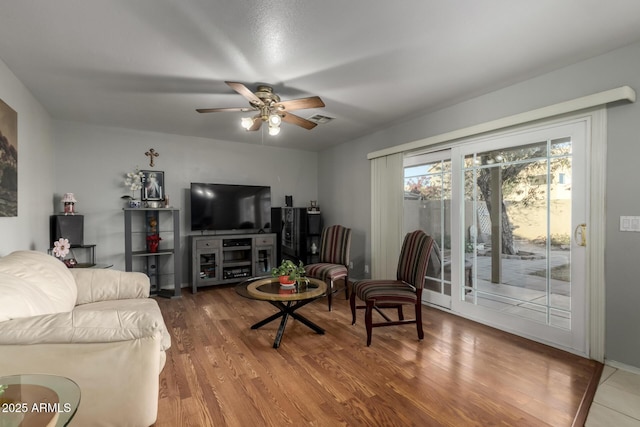 living room with ceiling fan and hardwood / wood-style flooring