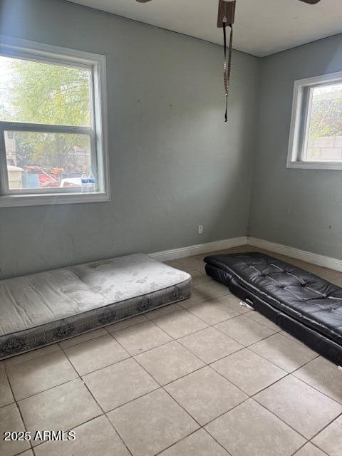unfurnished bedroom featuring tile patterned flooring and baseboards
