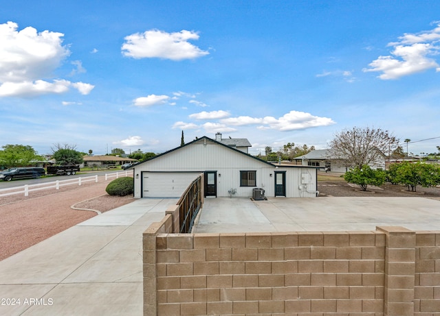 view of front of property featuring a garage and an outdoor structure