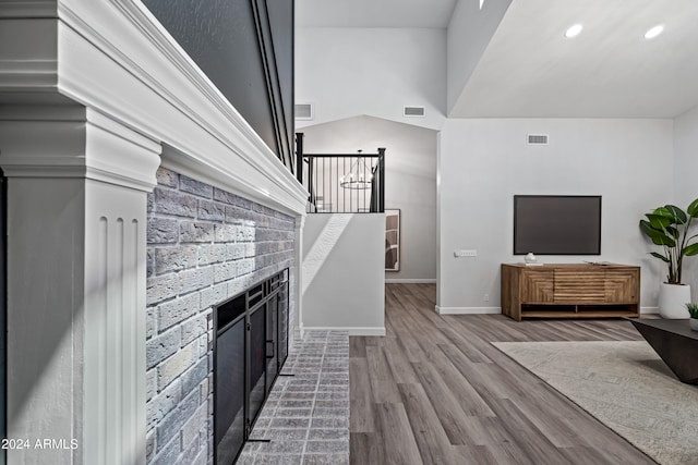 living room with high vaulted ceiling and wood-type flooring