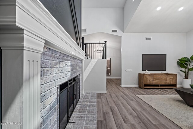 394 E Redfield Rd, Chandler, AZ 85225 - unfurnished living room with a brick fireplace, wood finished floors, recessed lighting, and baseboards