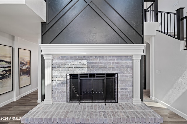 interior details with hardwood / wood-style flooring and a brick fireplace