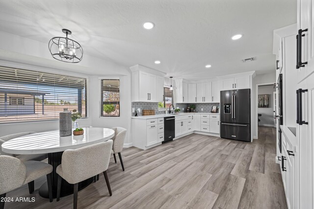 394 E Redfield Rd, Chandler, AZ 85225 - kitchen featuring refrigerator with ice dispenser, black dishwasher, tasteful backsplash, light wood-type flooring, and light countertops