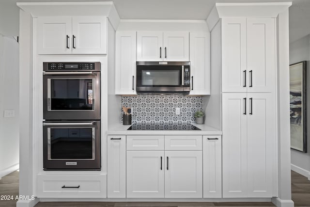 kitchen featuring tasteful backsplash, white cabinets, and appliances with stainless steel finishes