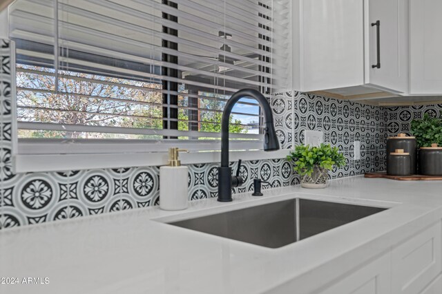394 E Redfield Rd, Chandler, AZ 85225 - kitchen view of tasteful backsplash, a sink, white cabinetry, and light countertops