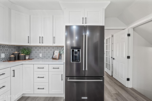 kitchen featuring tasteful backsplash, white cabinetry, and high end fridge