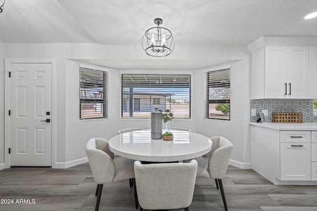 dining space featuring light hardwood / wood-style flooring and a notable chandelier