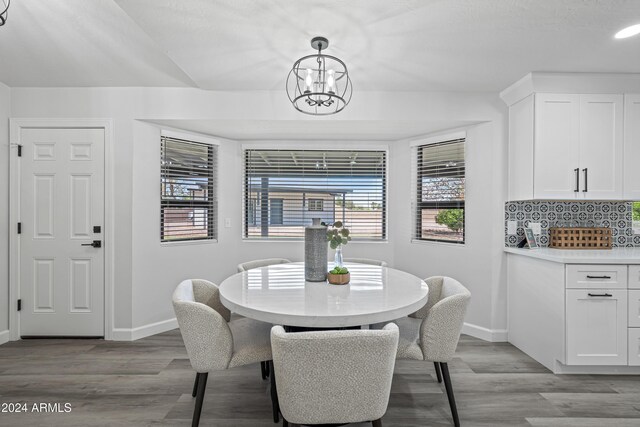 394 E Redfield Rd, Chandler, AZ 85225 - dining space featuring baseboards, light wood-style floors, and a chandelier