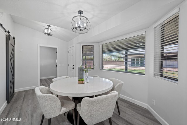 394 E Redfield Rd, Chandler, AZ 85225 - dining space featuring a barn door, a chandelier, baseboards, wood finished floors, and lofted ceiling