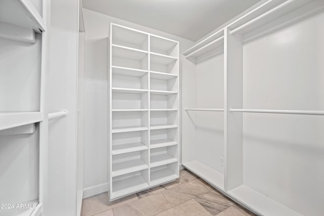 walk in closet featuring light tile patterned floors