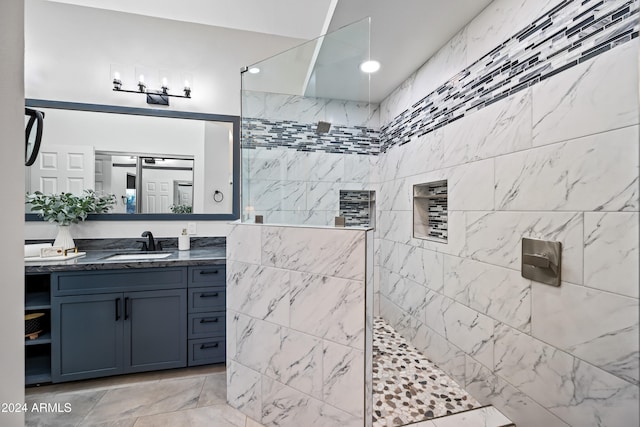 bathroom featuring vanity and a tile shower