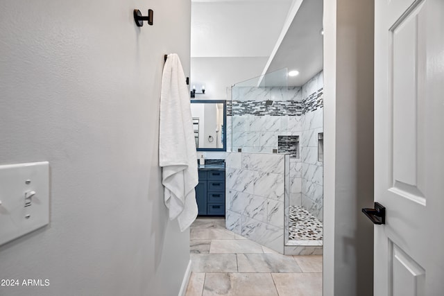 bathroom featuring vanity and tiled shower