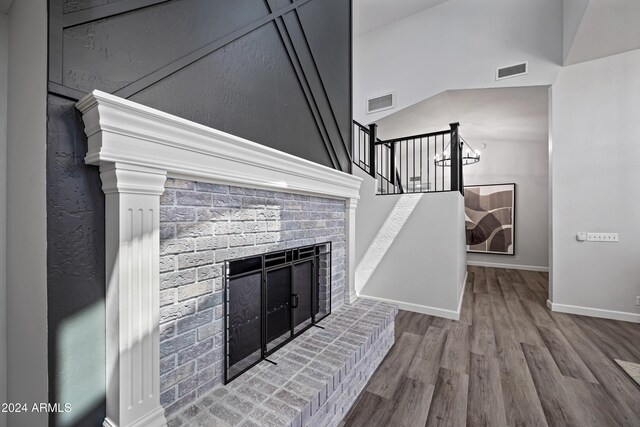 394 E Redfield Rd, Chandler, AZ 85225 - unfurnished living room featuring a brick fireplace, wood finished floors, baseboards, and stairway