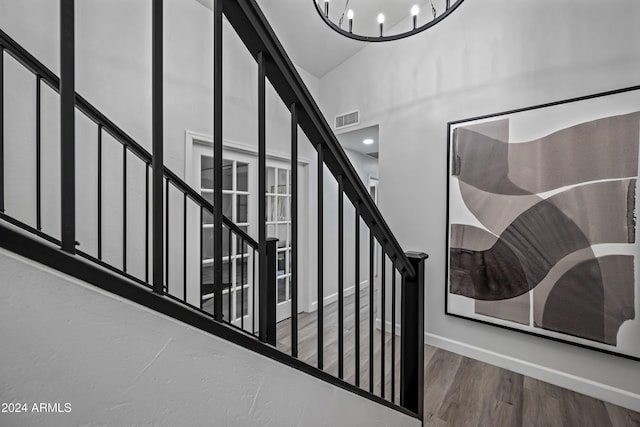 394 E Redfield Rd, Chandler, AZ 85225 - stairs with a chandelier, wood finished floors, a high ceiling, and baseboards