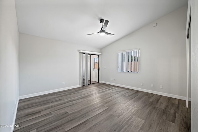 empty room featuring ceiling fan, dark hardwood / wood-style flooring, and vaulted ceiling