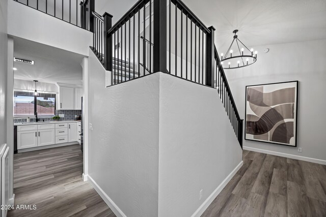 394 E Redfield Rd, Chandler, AZ 85225 - staircase with a chandelier, wood finished floors, baseboards, and a towering ceiling