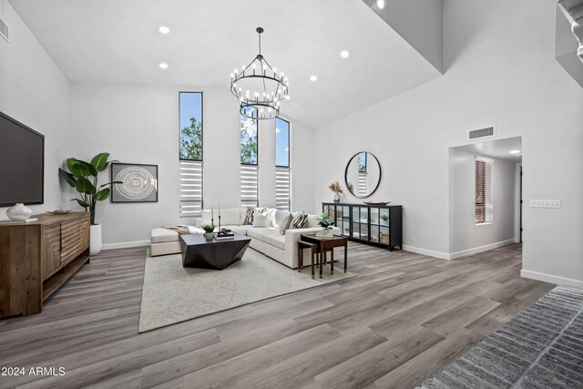394 E Redfield Rd, Chandler, AZ 85225 - living area with a high ceiling, baseboards, wood finished floors, a chandelier, and recessed lighting