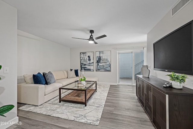 living room with ceiling fan and light wood-type flooring