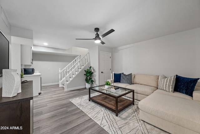 living room with ceiling fan and light wood-type flooring