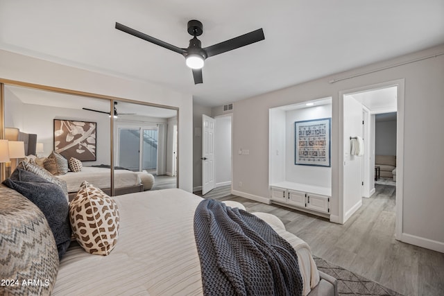 bedroom featuring ceiling fan, light wood-type flooring, and a closet