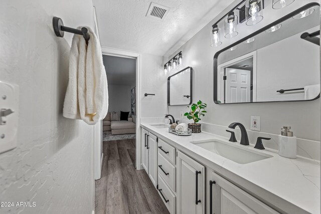 394 E Redfield Rd, Chandler, AZ 85225 - full bathroom featuring double vanity, a textured ceiling, wood finished floors, and connected bathroom