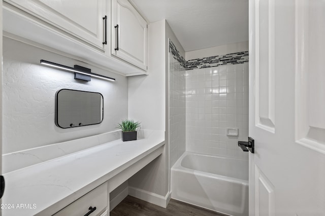 bathroom with vanity, tiled shower / bath, and hardwood / wood-style flooring