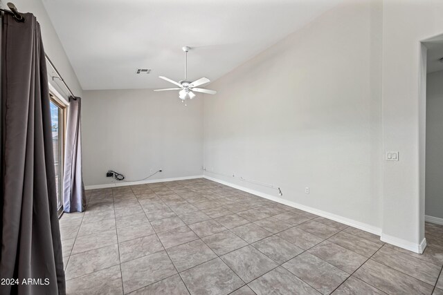394 E Redfield Rd, Chandler, AZ 85225 - spare room featuring vaulted ceiling, ceiling fan, light tile patterned flooring, and baseboards