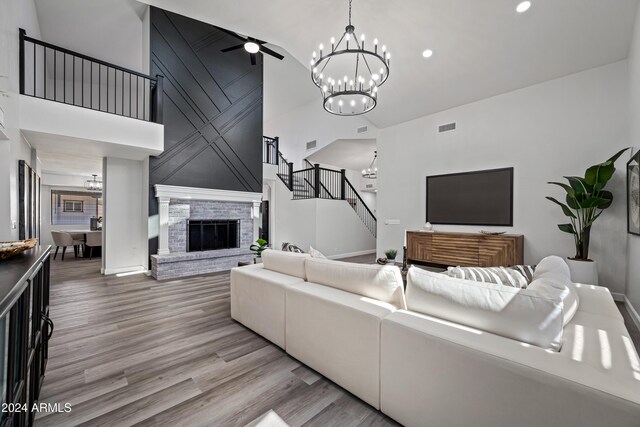 394 E Redfield Rd, Chandler, AZ 85225 - living area featuring a chandelier, high vaulted ceiling, stairway, a brick fireplace, and wood finished floors
