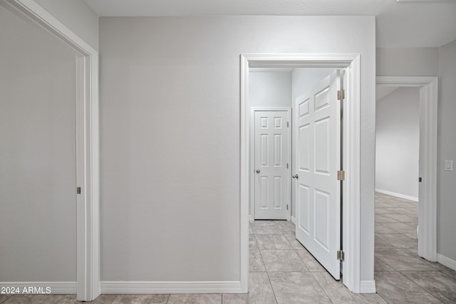 hall featuring light tile patterned floors