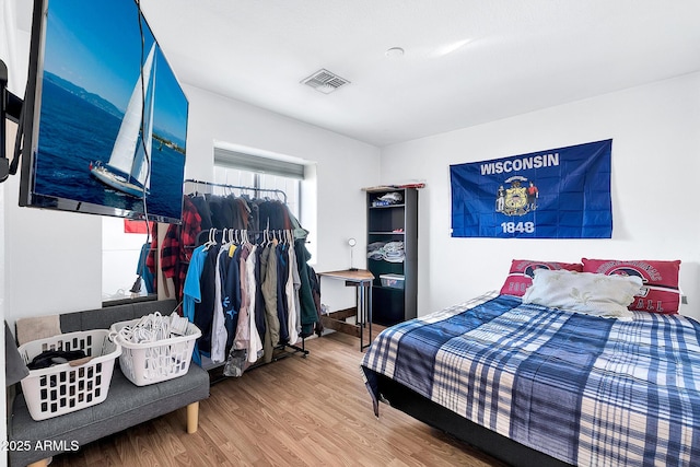 bedroom with hardwood / wood-style flooring and a closet