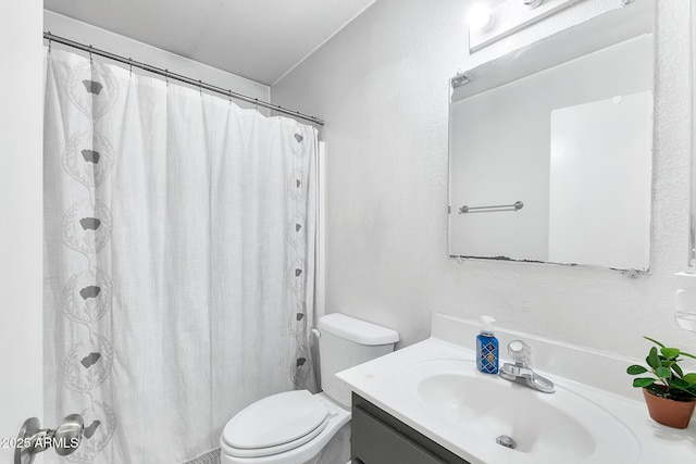 bathroom with a shower with curtain, vanity, and toilet