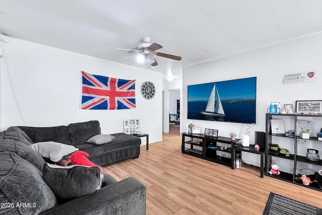 living room featuring hardwood / wood-style floors and ceiling fan