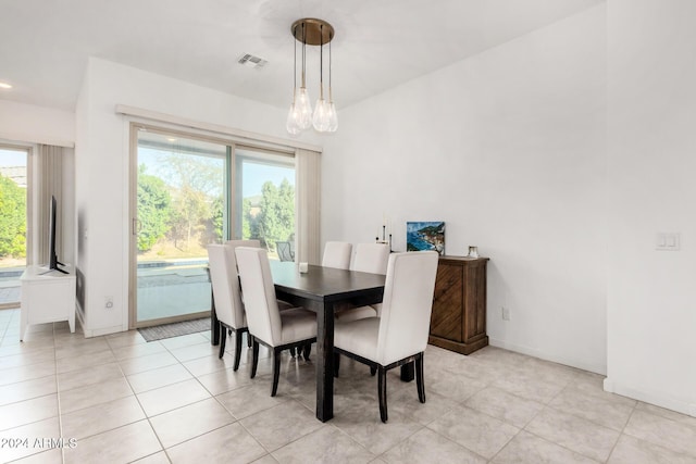 17966 W Highland Ave, Goodyear, AZ 85395 - dining room featuring baseboards, light tile patterned floors, a notable chandelier, and visible vents