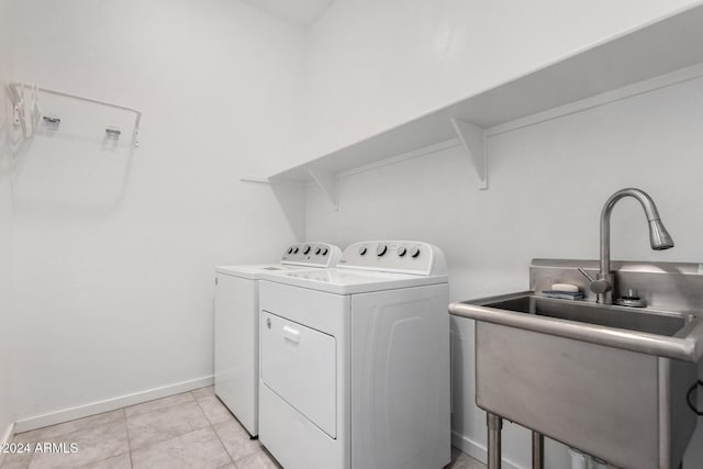 17966 W Highland Ave, Goodyear, AZ 85395 - laundry room with light tile patterned floors, baseboards, a sink, laundry area, and washer and clothes dryer