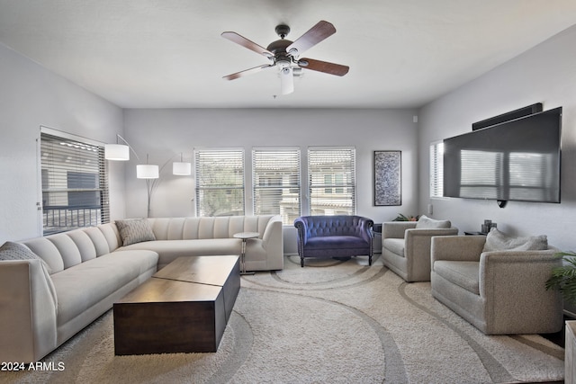 carpeted living area featuring ceiling fan