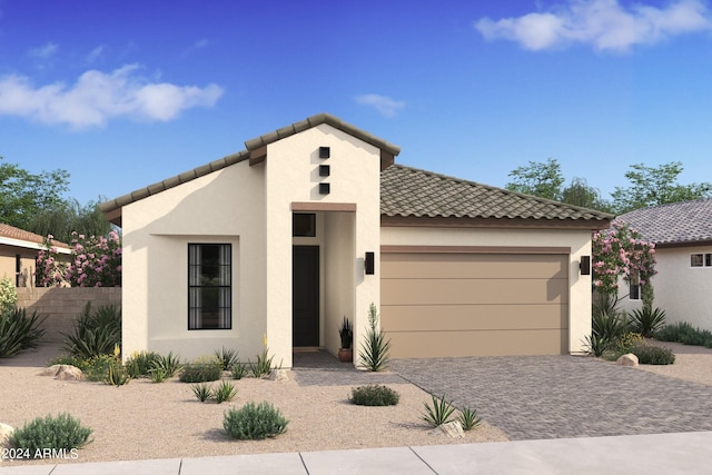 mediterranean / spanish-style house featuring fence, a tiled roof, stucco siding, decorative driveway, and an attached garage