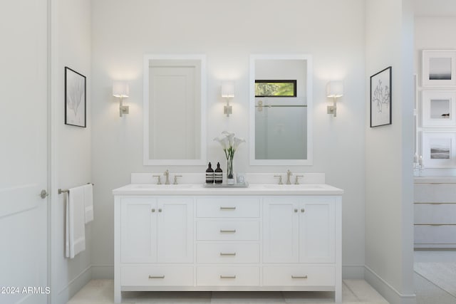 bathroom featuring double vanity, baseboards, and a sink