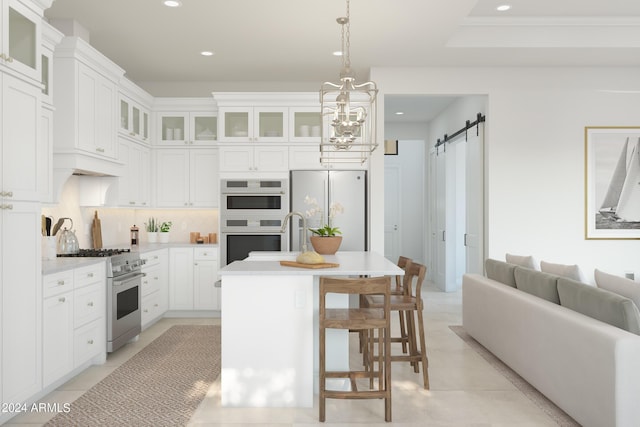 kitchen featuring recessed lighting, stainless steel appliances, a barn door, tasteful backsplash, and a center island