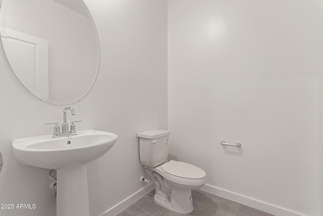 bathroom featuring tile patterned floors and toilet