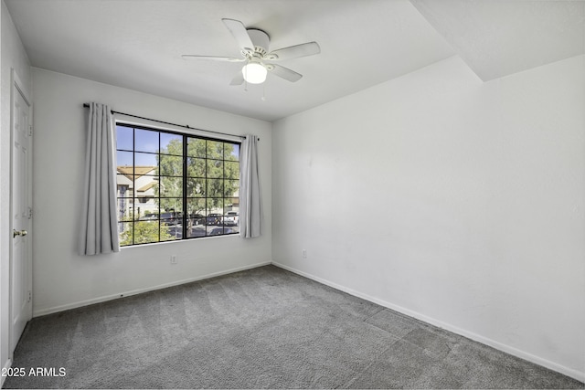 empty room with ceiling fan, baseboards, and carpet flooring