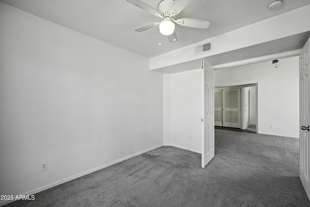 spare room with a ceiling fan, baseboards, visible vents, and carpet flooring