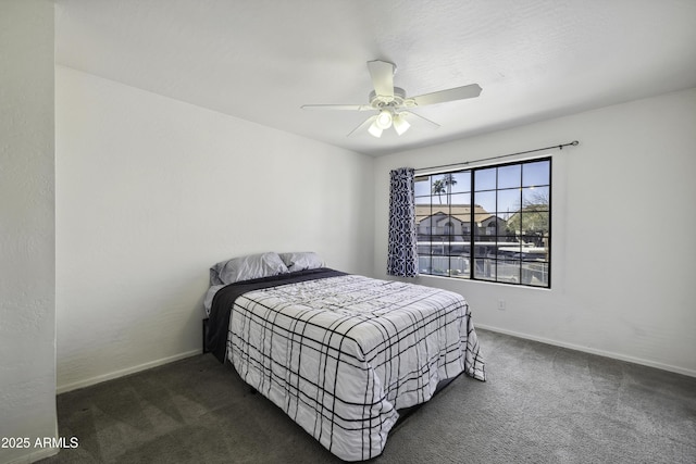 bedroom featuring ceiling fan, dark carpet, and baseboards