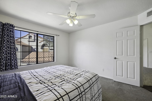 carpeted bedroom with ceiling fan and baseboards