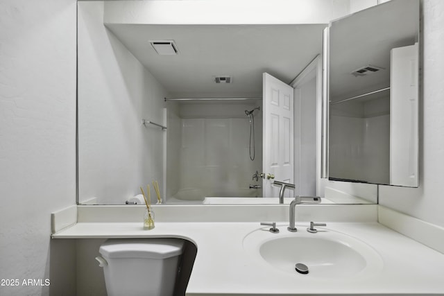 bathroom featuring visible vents, vanity, and toilet